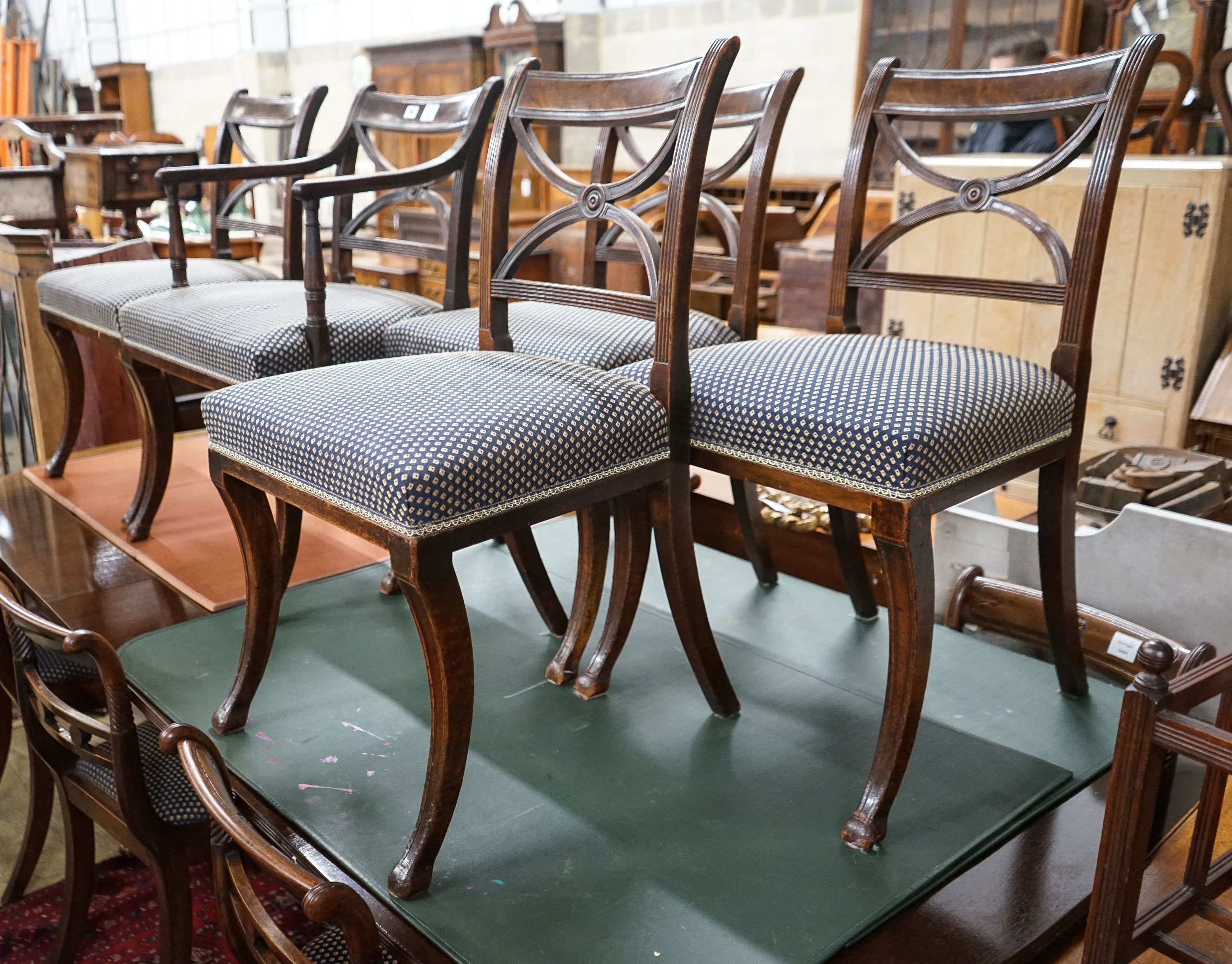 A set of five Regency mahogany dining chairs, (one with arms, four single)